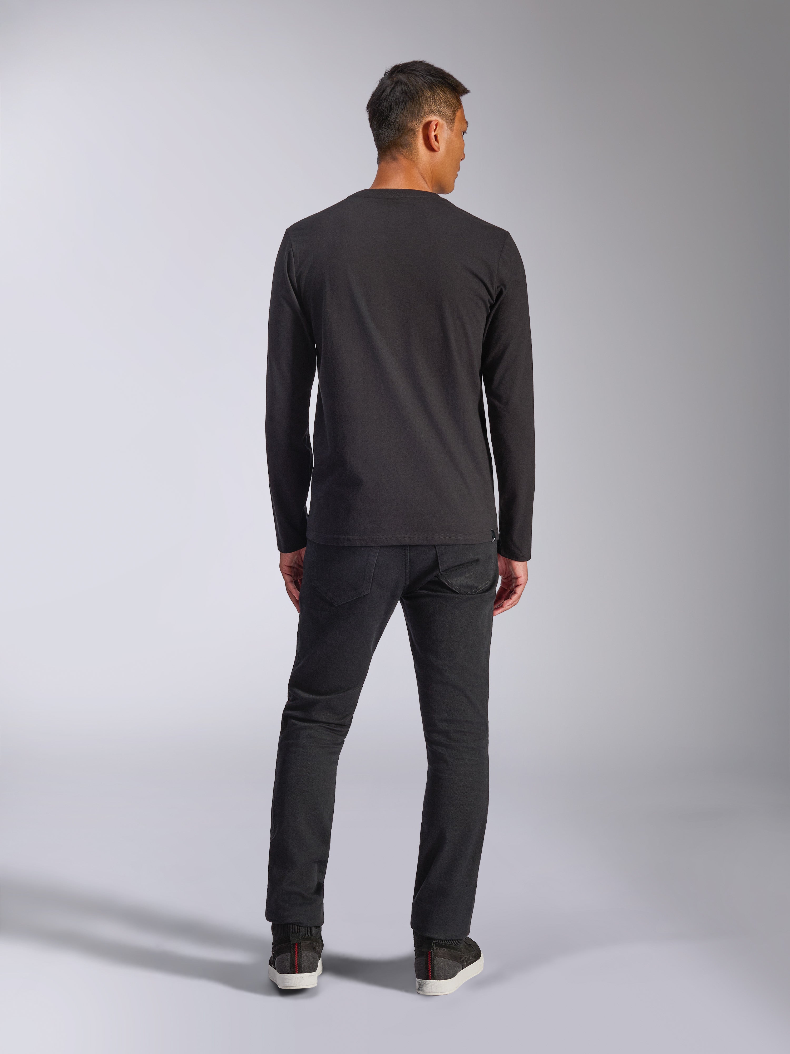 Alpinestars Trackside CSF Tee, t-shirt à manches longues, noir, vue arrière du mannequin portant le t-shirt avec un pantalon sombre, streetwear décontracté inspiré du sport automobile