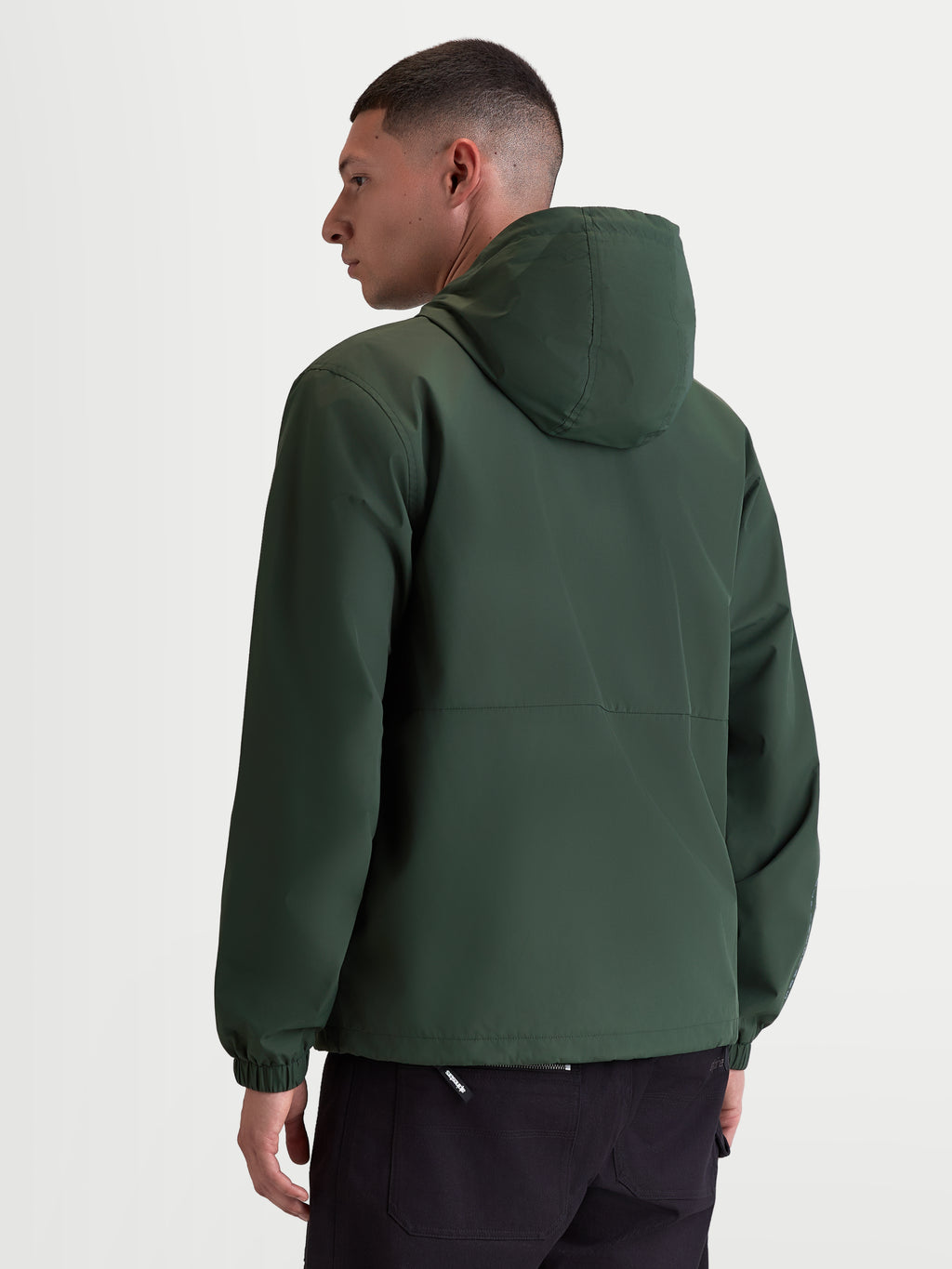 Alpinestars Speeder Resolve Windbreaker Jacket, Lightweight Sportswear Hooded Outerwear for Urban Use, Pine Green, Windproof 100% Polyester with Mesh Lining, Rear view on model highlighting the clean back design and elastic cuffs.