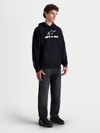 Alpinestars Prelude Oversized Hoodie, Men's Sportswear Fleece Pullover, Black with White puff-print logo, featuring a relaxed oversized fit and kangaroo pocket, shown on a model.