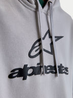Alpinestars Prelude Oversized, sweat à capuche sportswear unisexe, gris ciment et noir, gros plan sur le logo et l'étoile en impression en relief, cordons de serrage plats