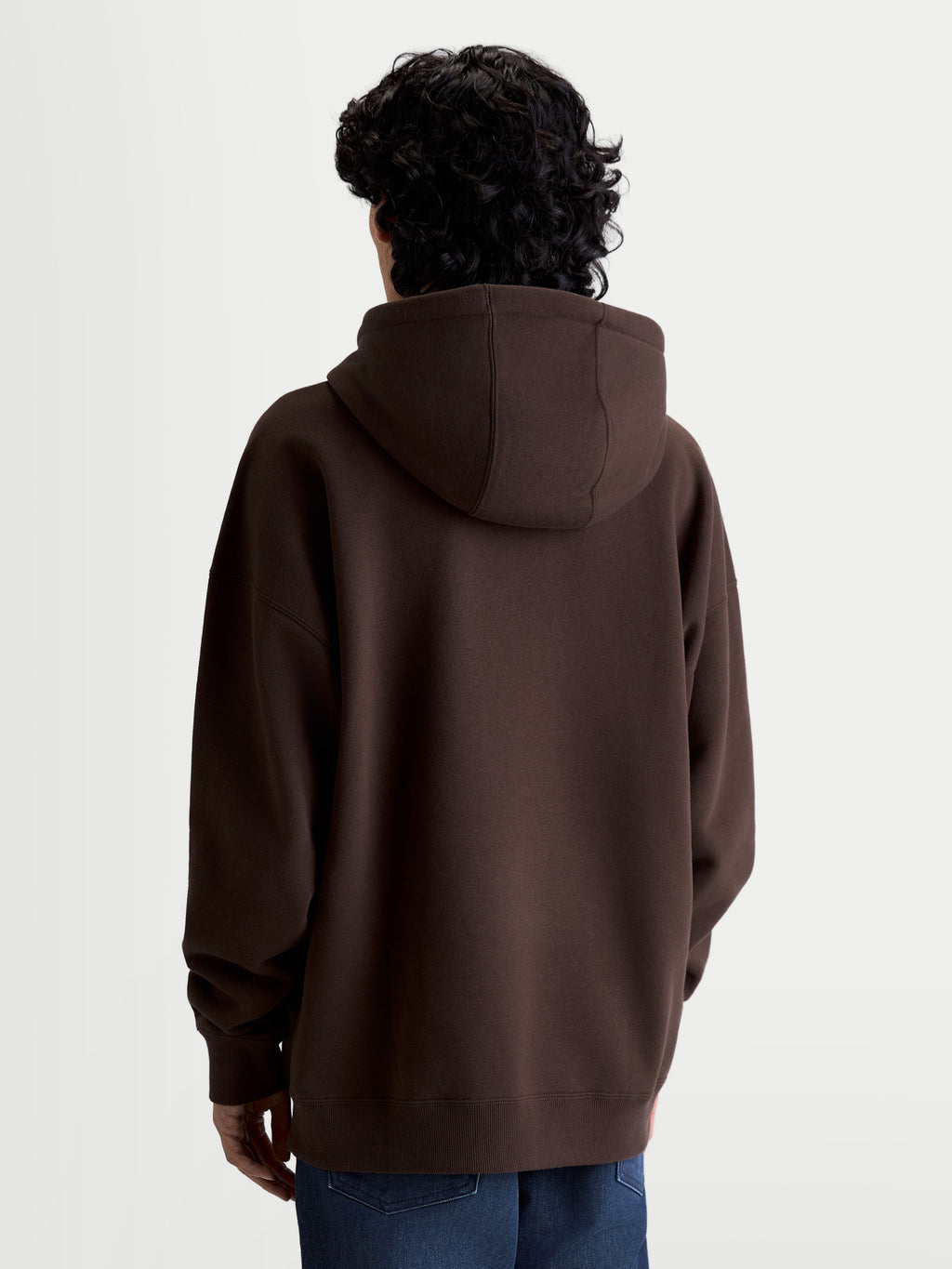 Alpinestars Sweat à capuche Prelude Oversized, sweat de sportswear marron en polaire, vue de dos montrant une silhouette décontractée, capuche doublée, poignets et ourlet côtelés, vêtement décontracté premium