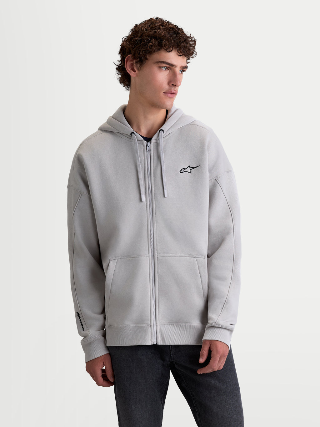 Alpinestars Sweat à capuche Entity Oversized, sweat à capuche zippé sportswear pour homme, gris ciment, avec zip frontal Vislon, poche kangourou et logo Astars brodé sur la poitrine, coupe décontractée en polaire.
