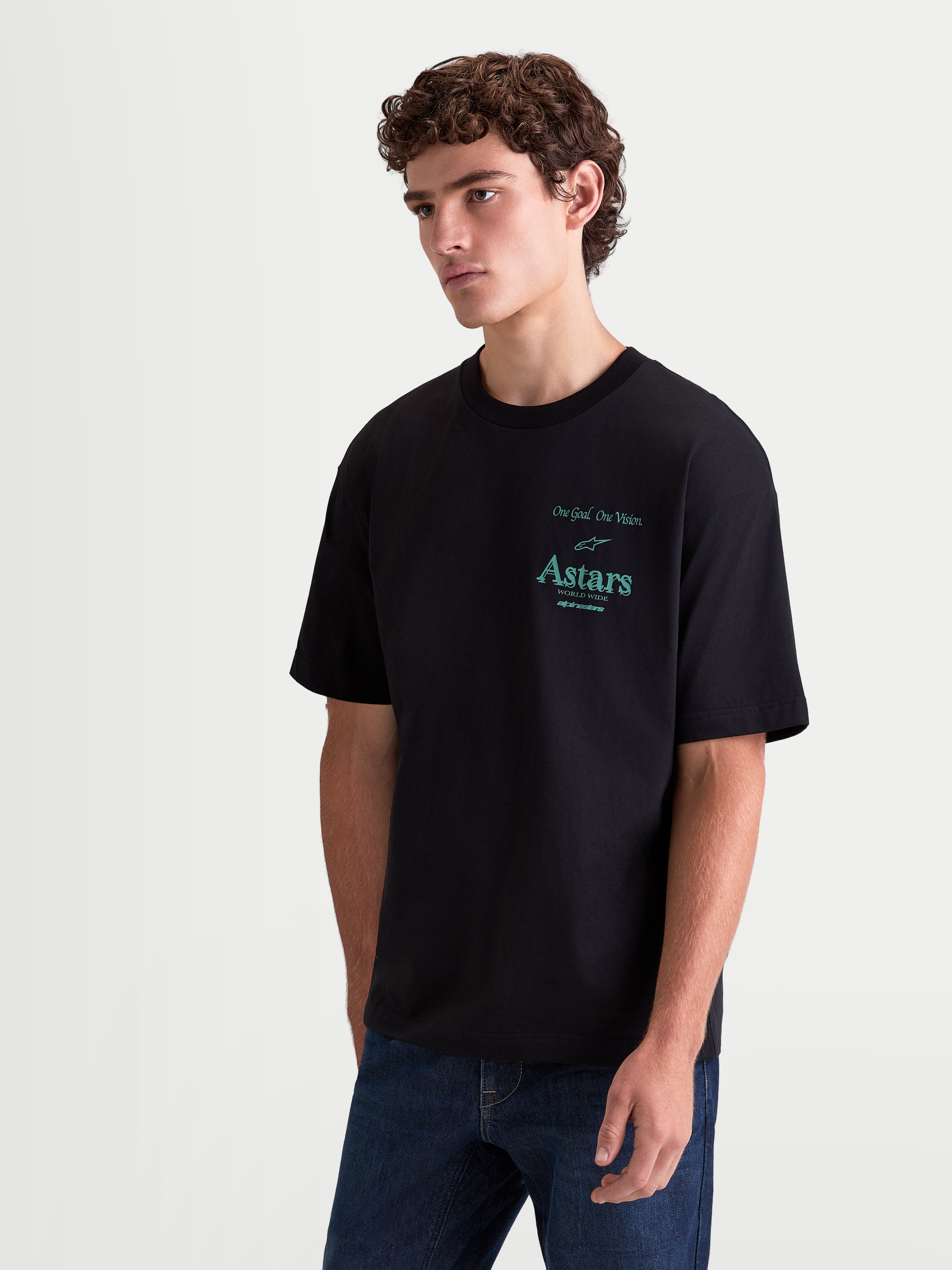 Alpinestars Post Oversized CSF Tee, Black Short Sleeve Sportswear T-Shirt on model, featuring a teal Astars logo graphic on the chest, oversized fit, premium cotton blend for casual everyday comfort.