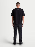 Alpinestars Mandate Oversized CSF, t-shirt sportswear à manches courtes unisexe, noir, coupe ample et décontractée, mélange de coton et polyester, vue de dos sur mannequin avec graphismes blancs en impression puff sur le col et la manche.