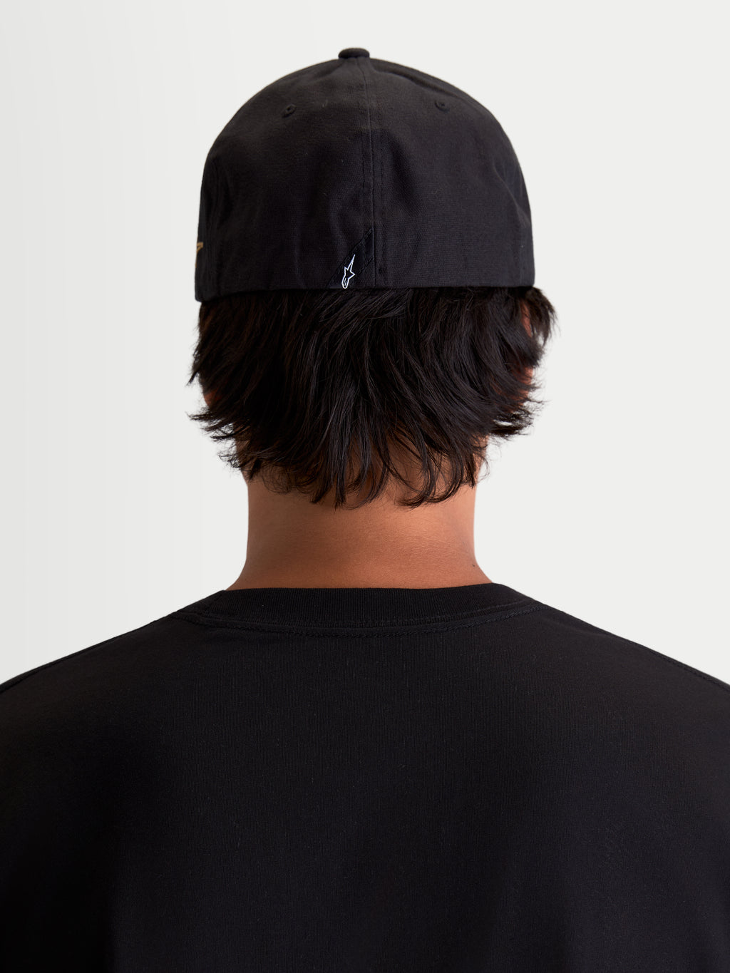 Alpinestars County Canvas Hat, Black Sportswear Cap, Rear View on Model, featuring Flex-back fit and small embroidered Astars logo on the back, Oxford peached canvas material for everyday comfort.