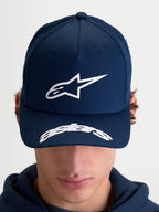 Alpinestars Arclight Hat, Motorsport-inspired Sportswear Baseball Cap for Men and Women, Navy Blue and White, featuring a structured crown with a textured puff-print Astars logo, curved bill with Astars wordmark detailing, durable cotton twill construction, on-model front view.