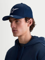 Alpinestars Arclight Hat, Navy Blue Sportswear Baseball Cap for Men and Women, featuring a curved bill with white puff-print Astars branding and a structured crown. On-model side profile view showing the hat's classic motorsport-inspired fit and durable cotton twill fabric.