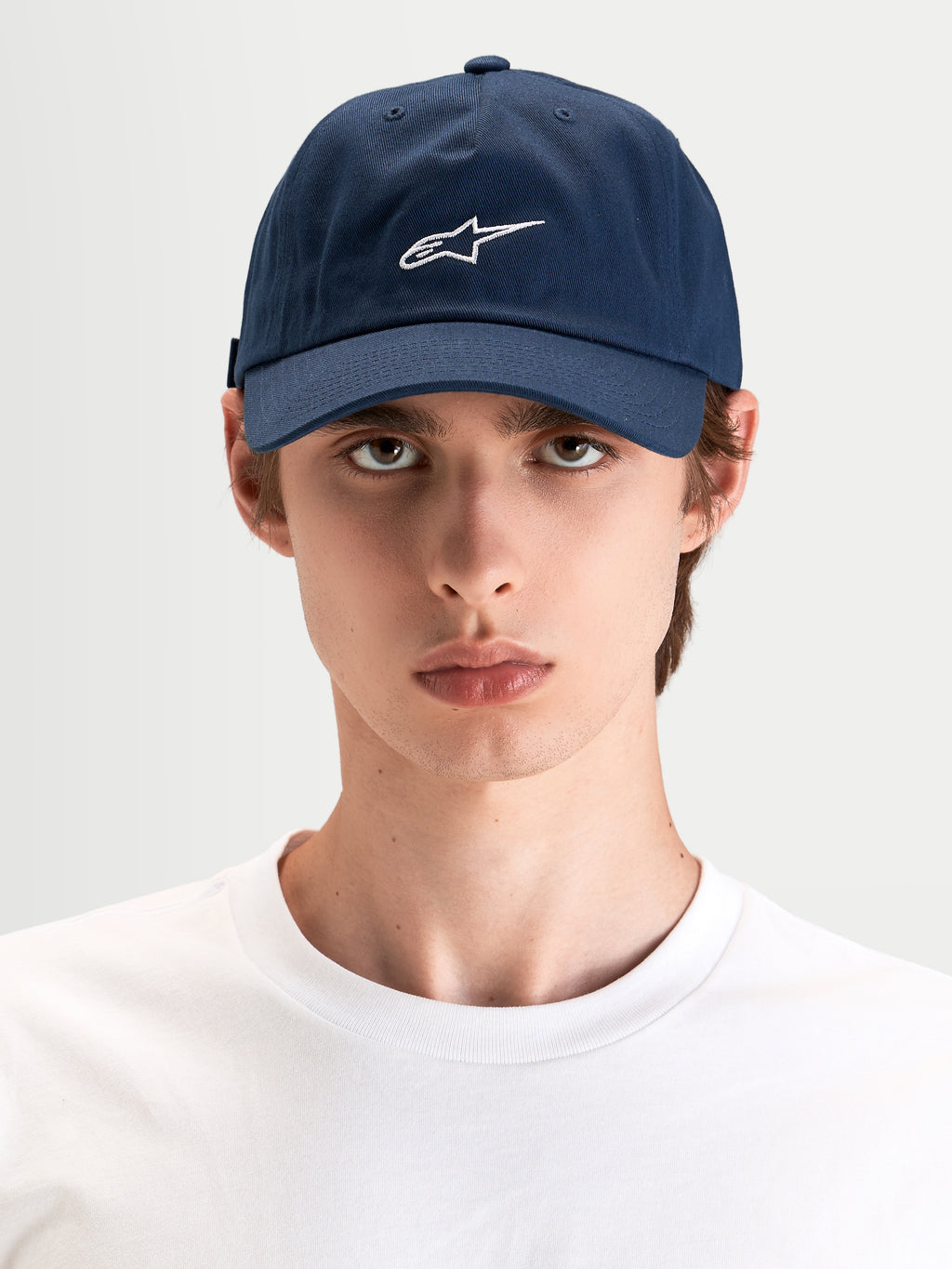 Alpinestars Dylan Dad Hat, casual sportswear cap in navy blue with white Astars logo embroidery, curved bill and unstructured low crown worn by a model