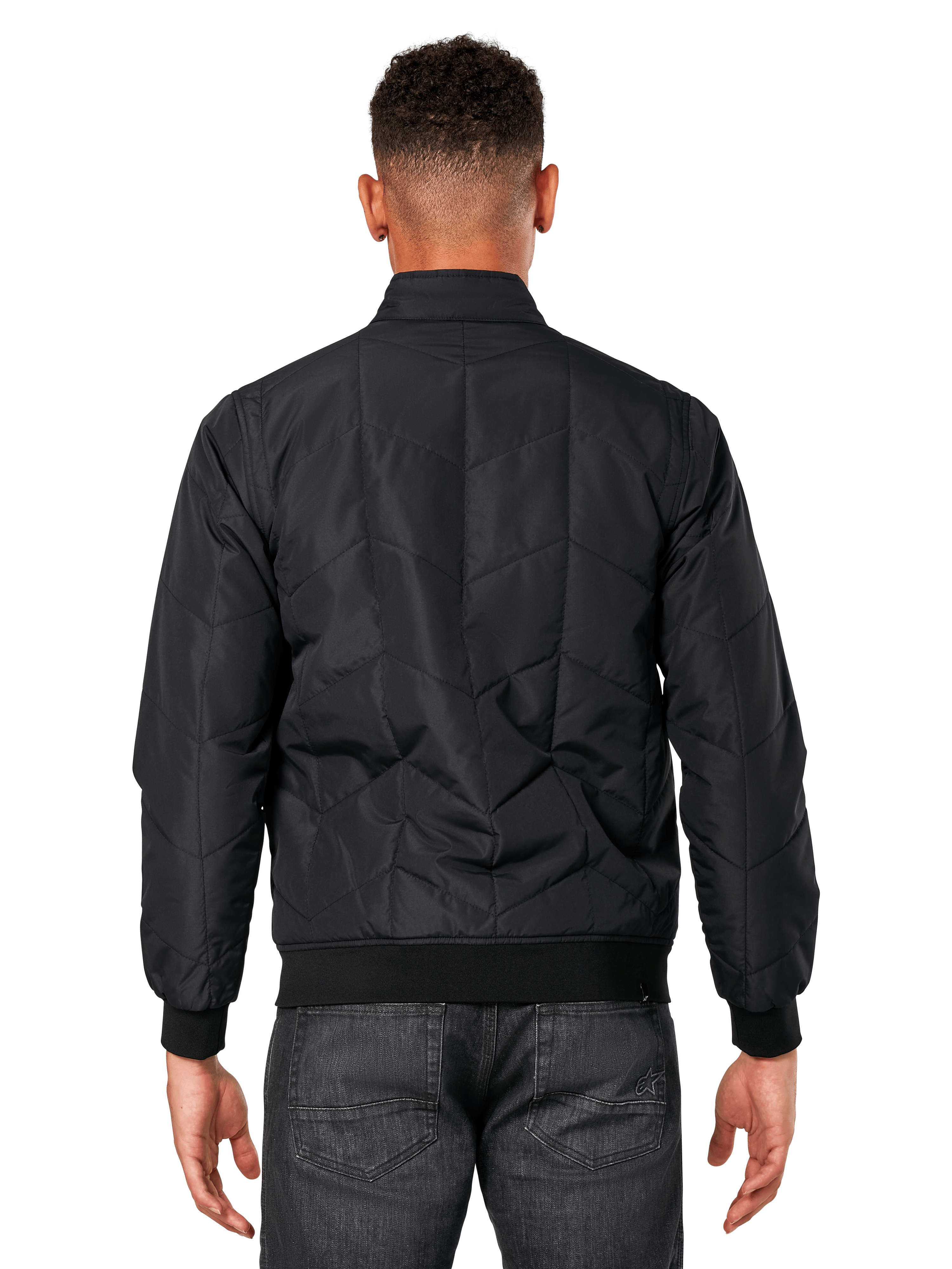 Veste Precedent Alpinestars, noir, vue de dos sur modèle, dotée d'un motif matelassé en angle iconique, poignets et ourlet en côtes, style motorsport matelassé inspiré de la F1