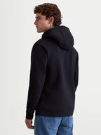 Alpinestars Sweat à capuche Ageless V3, sweat à capuche pull-over en polaire pour homme, noir, vue de dos montrant le design à capuche et les poignets côtelés, vêtement de style sportswear décontracté pour passionnés de sports mécaniques.