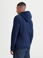 Alpinestars Sweat à capuche Ageless V3, sweat sportswear en polaire bleu marine, vue de dos sur un modèle, avec capuche doublée, poignets et ourlet côtelés, mélange de coton premium et polyester recyclé.