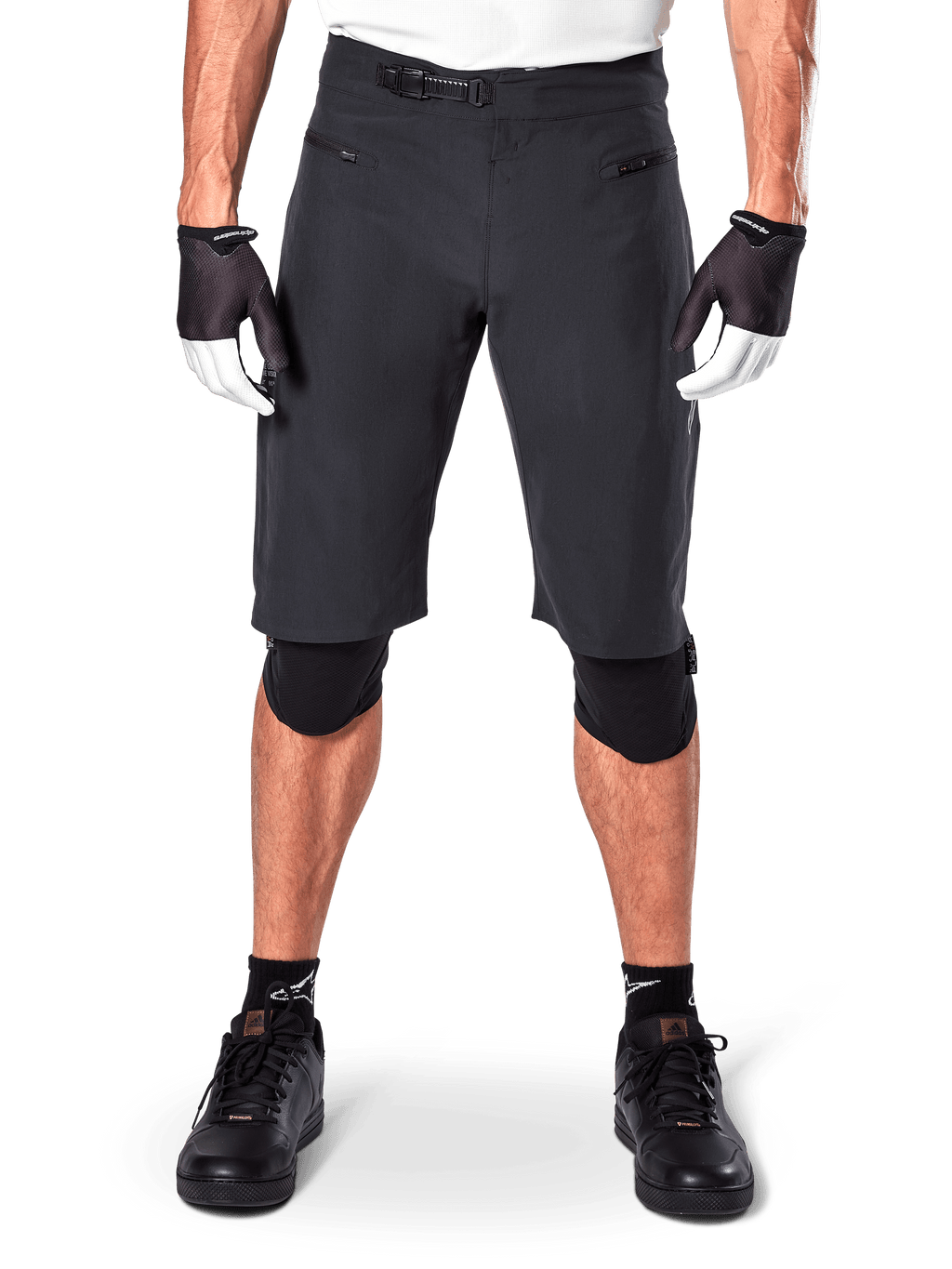 Alpinestars A-Aria Shorts, Black Mountain Bike Shorts, featuring a ratchet waist closure and zippered pockets, worn with black and white gloves and knee pads, technical cycling gear for off-road riding