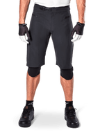Alpinestars A-Aria Shorts, Black Mountain Bike Shorts, featuring a ratchet waist closure and zippered pockets, worn with black and white gloves and knee pads, technical cycling gear for off-road riding