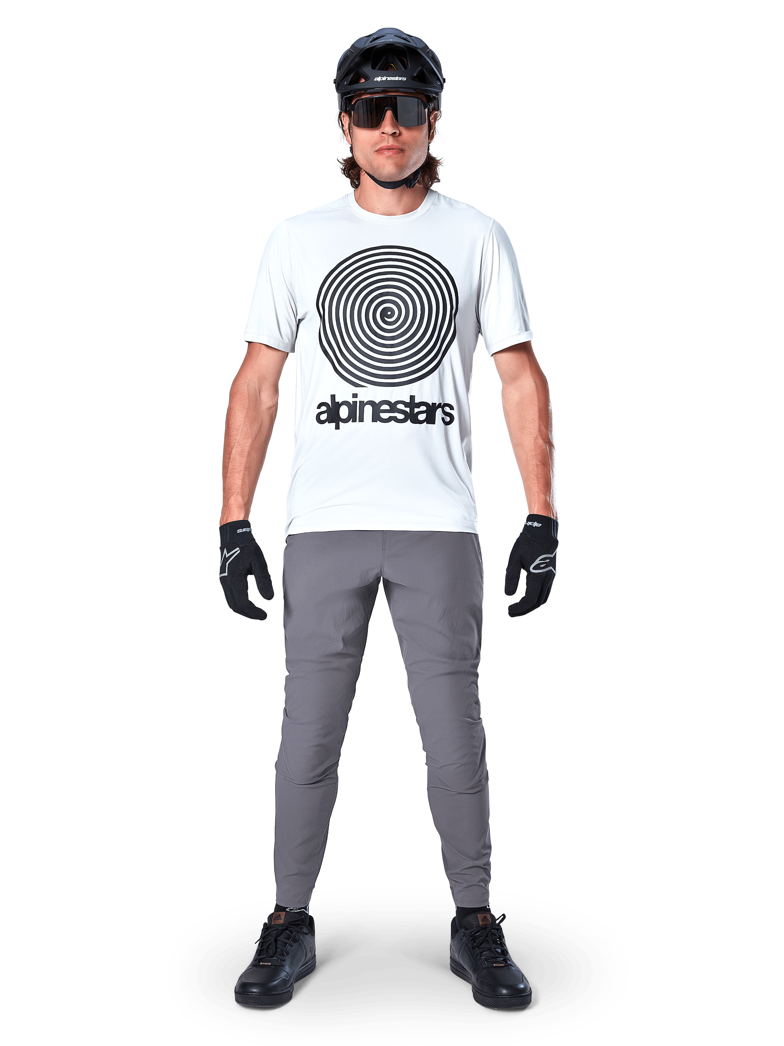 Alpinestars A-Dura Pants, MTB Cycling Pants, Dark Gray, worn with a white graphic t-shirt, black helmet, and gloves, featuring a durable 2-way stretch design and regular fit for mountain biking