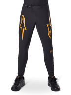 Alpinestars A-Supra Race Pants, MTB Cycling Pants, Black with bold orange logos, featuring a ratchet waist closure and laser-perforated ventilation, performance fit designed for off-road mountain bike racing