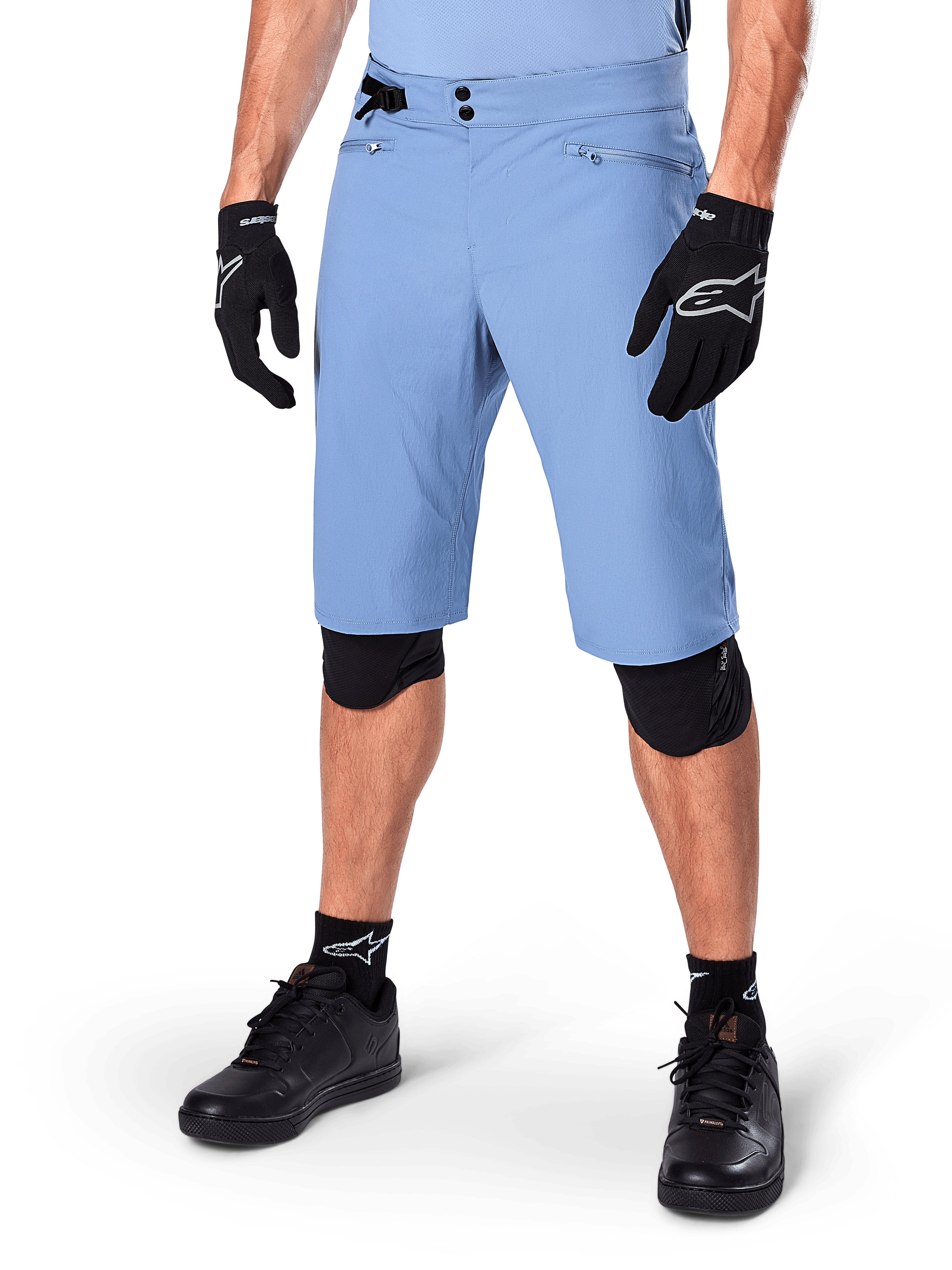 Alpinestars A-Dura Shorts, Infinity Blue, Mountain Bike Shorts, featuring zippered pockets and double snap closure, worn with black gloves and knee pads, durable 2-way stretch fabric for MTB