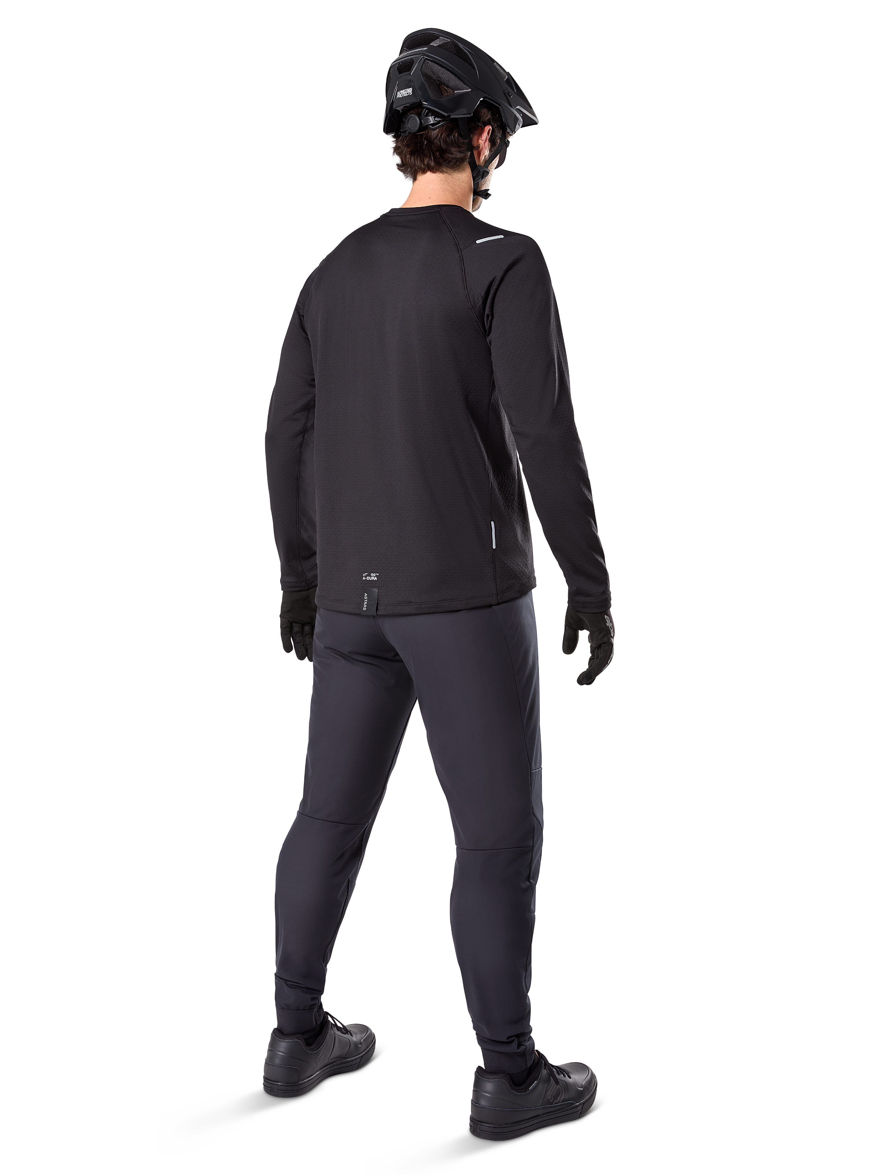 Alpinestars A-Dura Thermal Jersey, Men's Long-Sleeve Cycling Jersey, Black, rear view on model wearing a black MTB helmet, dark grey pants, and black gloves, professional mountain bike apparel for cold weather