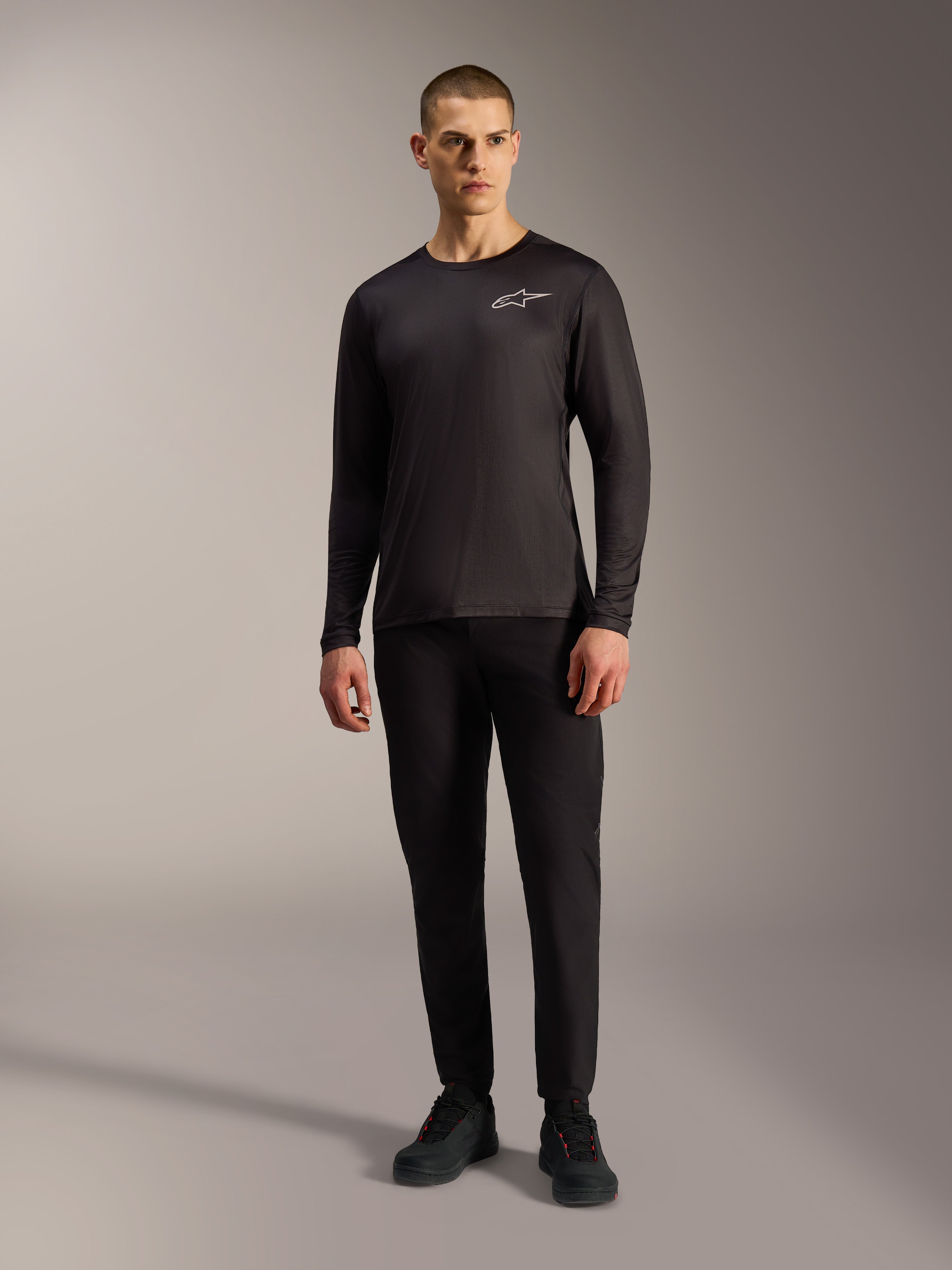 Maillot VTT noir A-Dura Air à manches longues, haut respirant avec logo Alpinestars blanc porté par un mannequin.