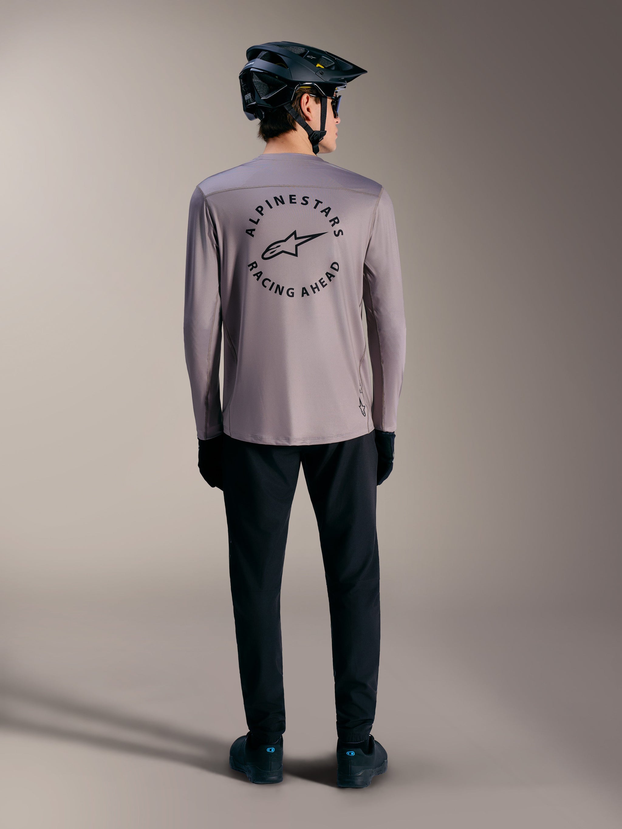 Gray A-Dura Air Long Sleeve Jersey with a circular Alpinestars Racing Ahead back graphic, moisture-wicking MTB apparel.