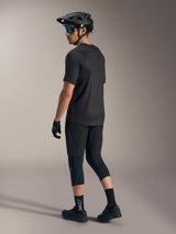 Black A-Dura Ride Short Sleeve Jersey, back view on a rider in MTB gear, featuring a poly-spandex blend for mobility.
