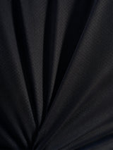 Black technical jacquard fabric detail of the A-Dura Ride Jersey, showcasing the breathable poly-spandex weave.