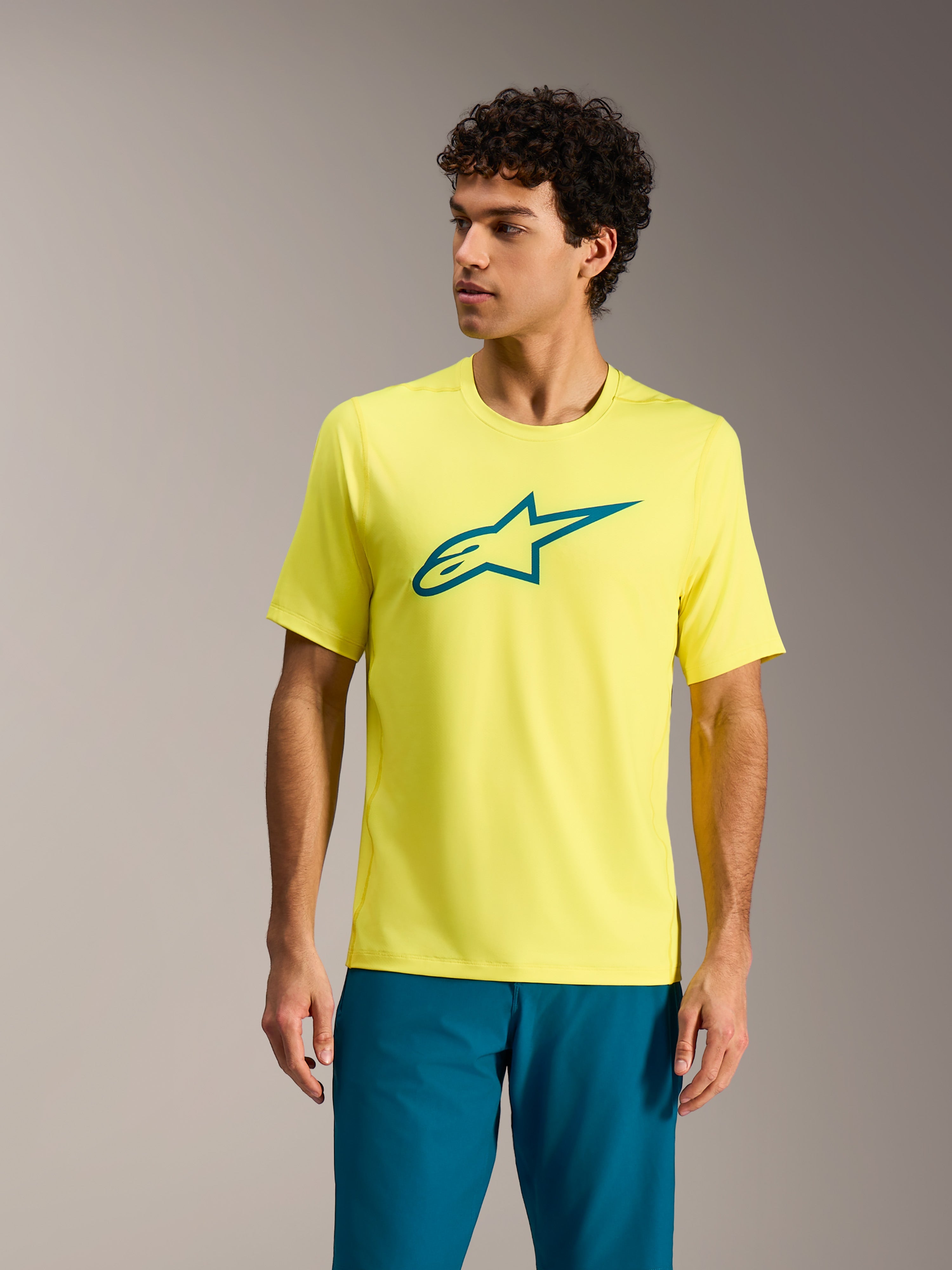 Maillot Alpinestars A-Dura Ride jaune fluo, haut de VTT à manches courtes avec logo sarcelle sur la poitrine.