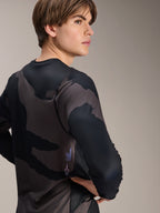 Alpinestars A-Dura Hollow Camo Long Sleeve Jersey, Black Camo, male model shown from the back side, featuring a dark camouflage pattern and screen-printed branding on the lower back, long sleeve performance MTB jersey