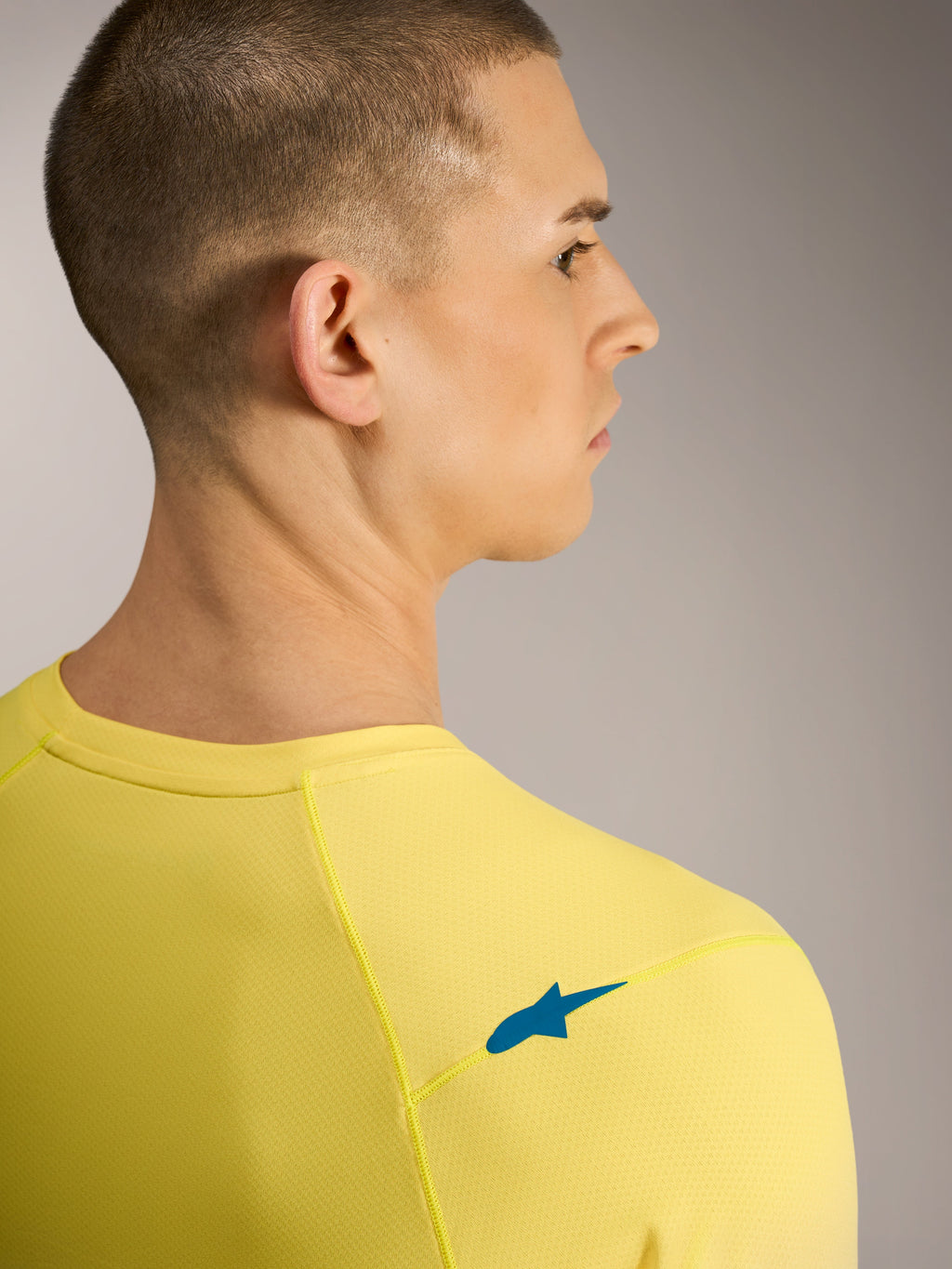 Maillot A-Dura ASTARS 2.0 jaune fluo, vue arrière avec logo bleu sur l'épaule et tissu jacquard VTT respirant.