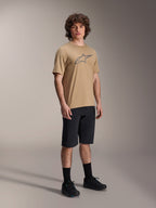 Alpinestars A-Dura Shorts, Black Mountain Bike Shorts, worn by a model with a tan short-sleeve jersey featuring the Alpinestars logo, black socks, and black shoes, durable MTB gear for off-road riding