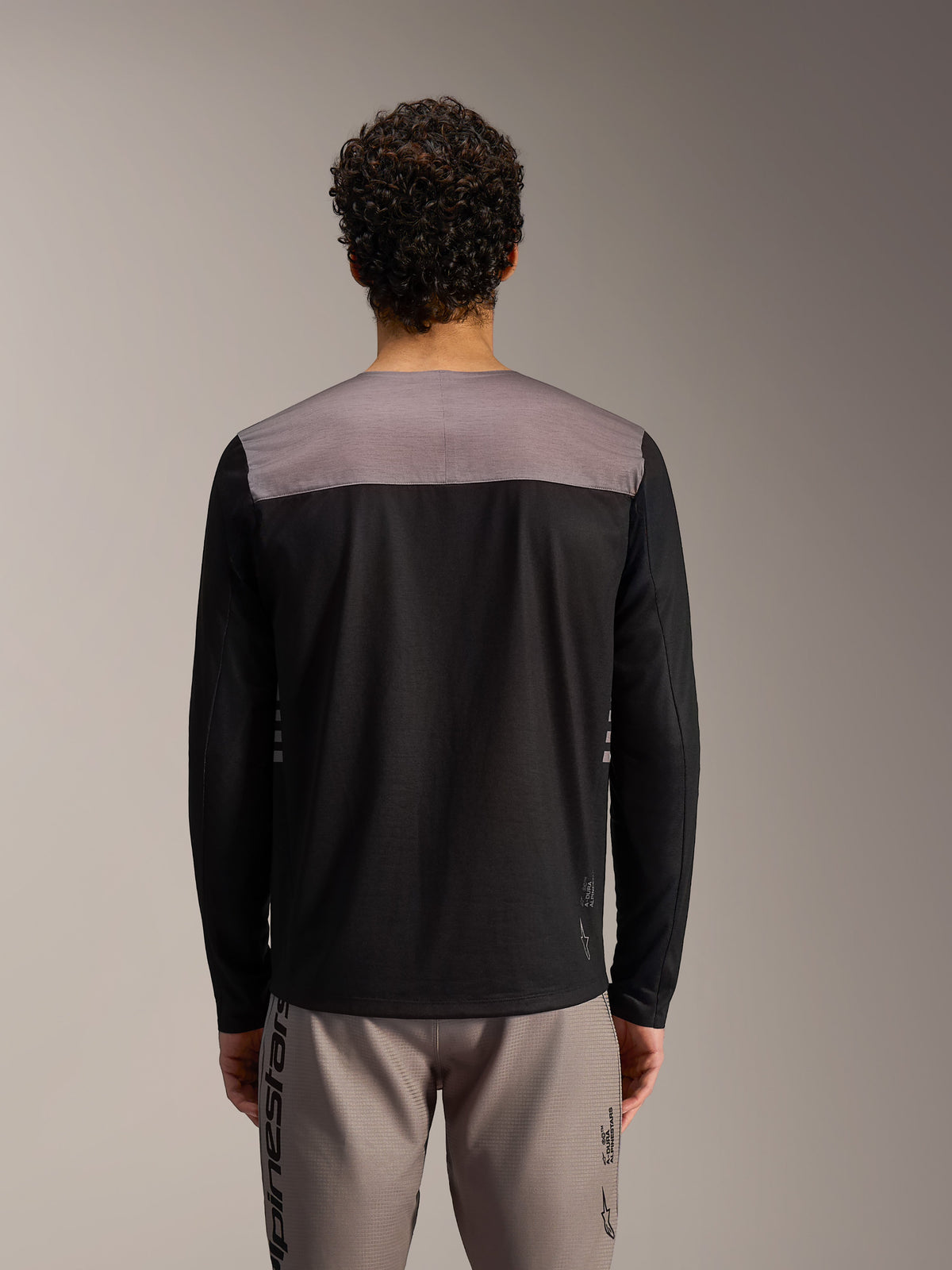 Maillot Alpinestars A-Dura Elite 2.0 noir à manches longues avec empiècement gris aux épaules, vue de dos.