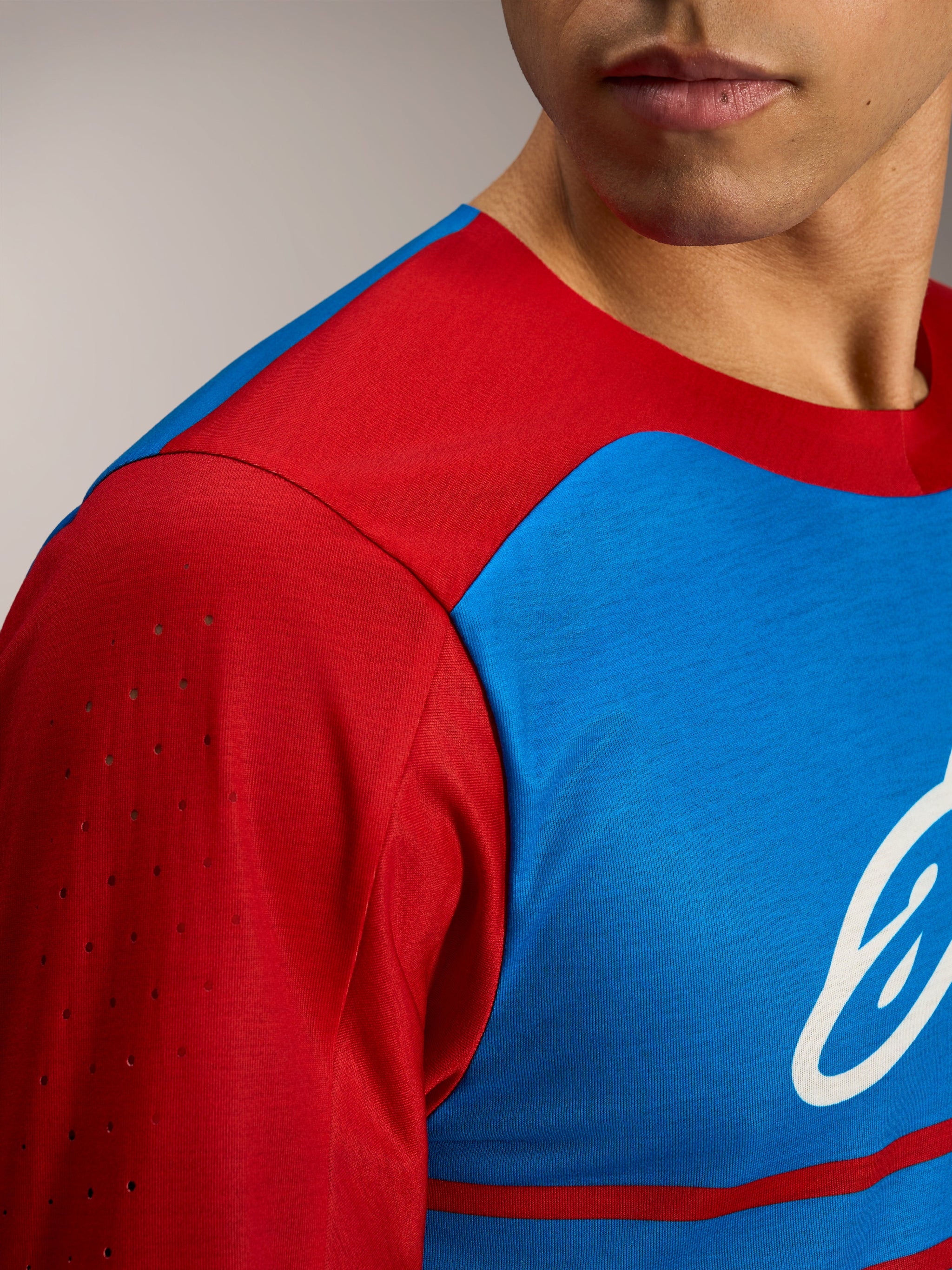 A-Dura Elite 2.0 Long Sleeve Jersey, red and blue color-blocked MTB top with breathable laser-cut sleeve perforations.