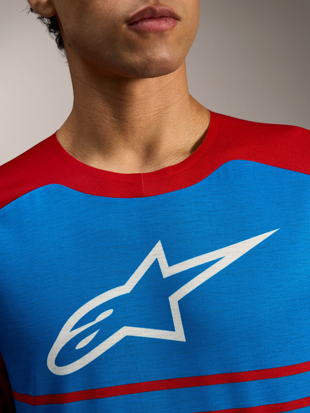 Maillot VTT Alpinestars A-Dura Elite 2.0 bleu et rouge, logo étoile blanc sur la poitrine.