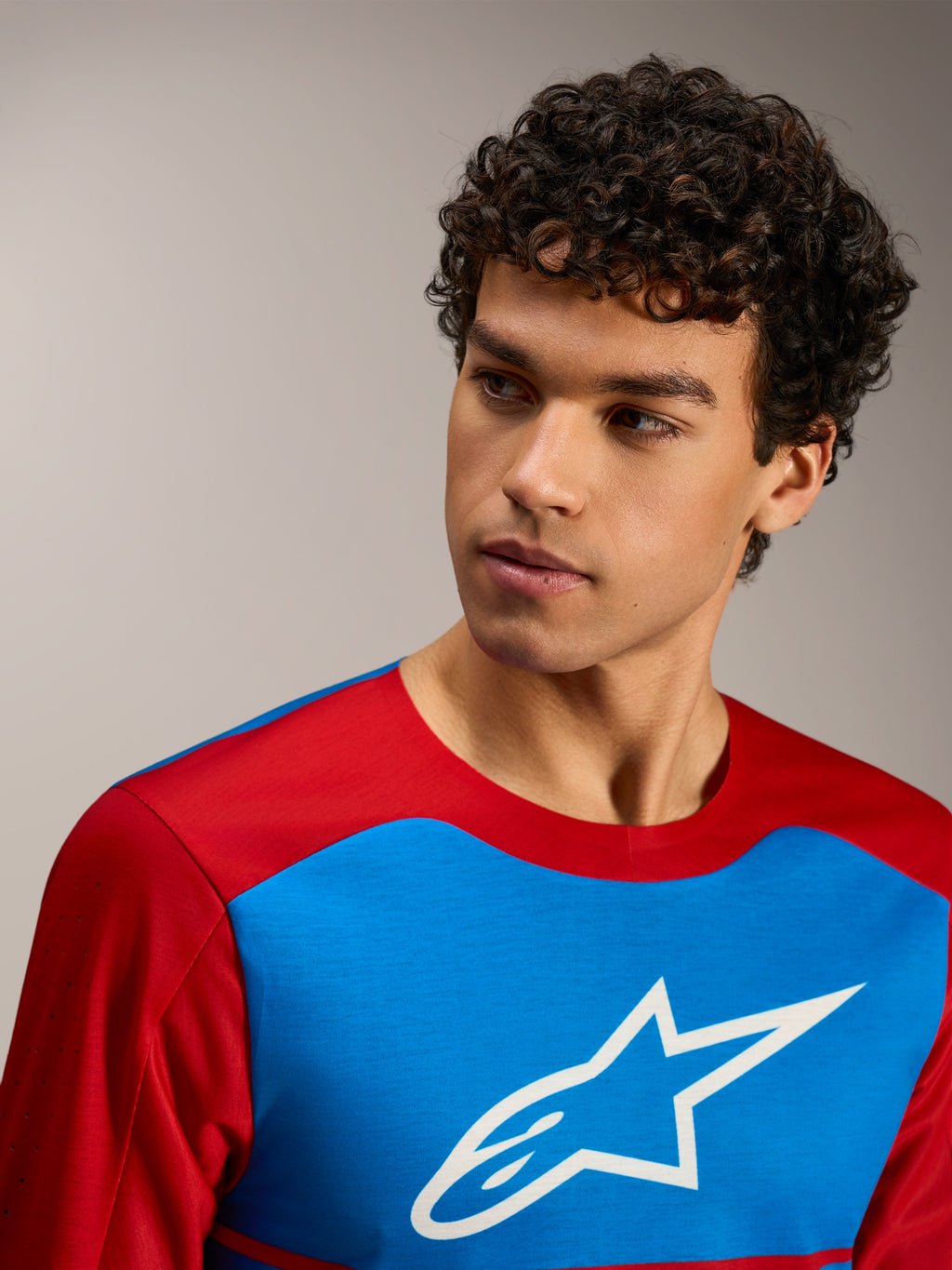 Maillot à manches longues A-Dura Elite 2.0 rouge et bleu avec logo blanc Alpinestars et tissu technique respirant.
