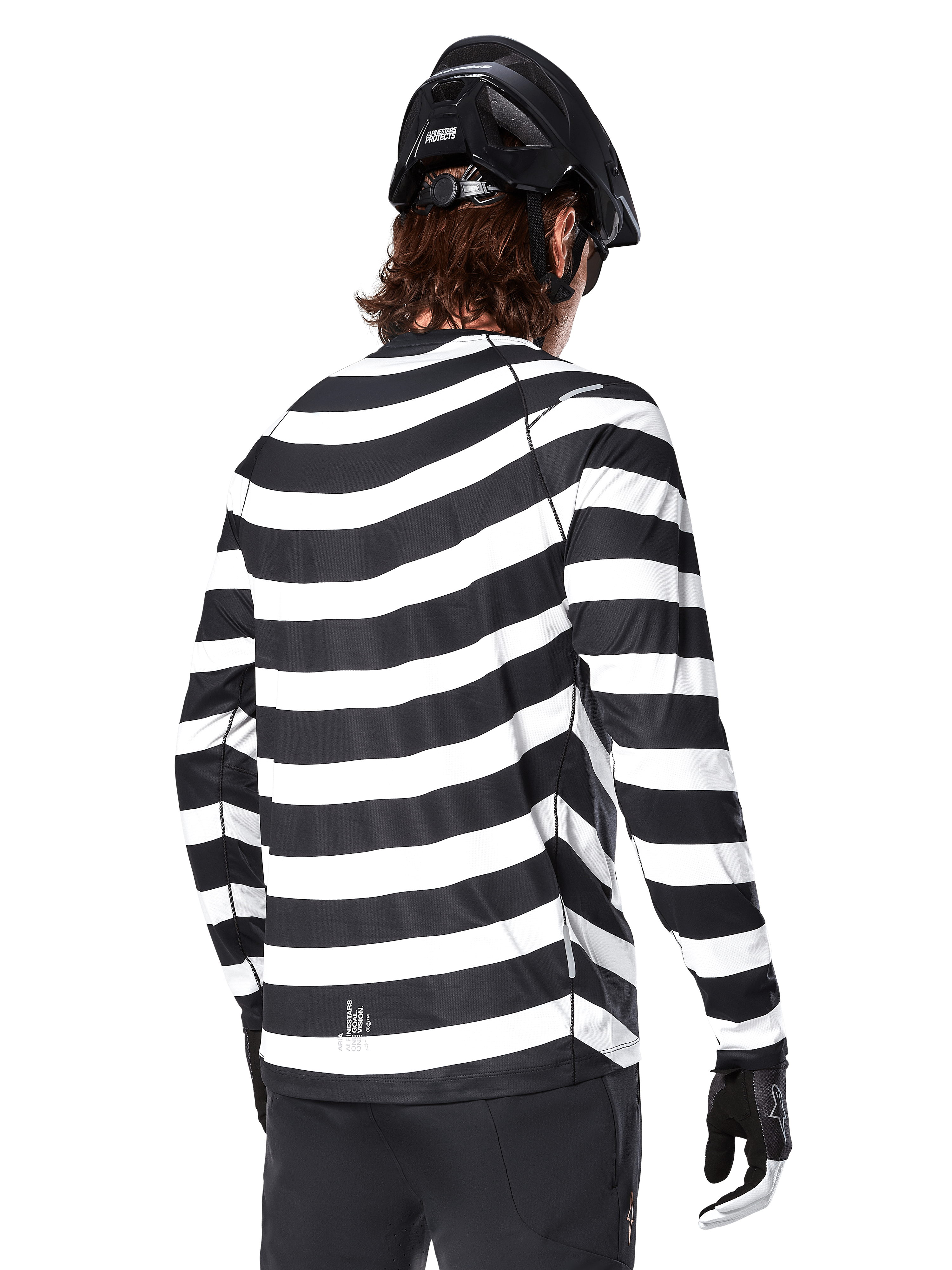 Alpinestars A-Aria Oscar Long Sleeve Jersey, back view, featuring bold black and white horizontal stripes, worn with a black mountain bike helmet and black pants, heritage-inspired performance MTB gear