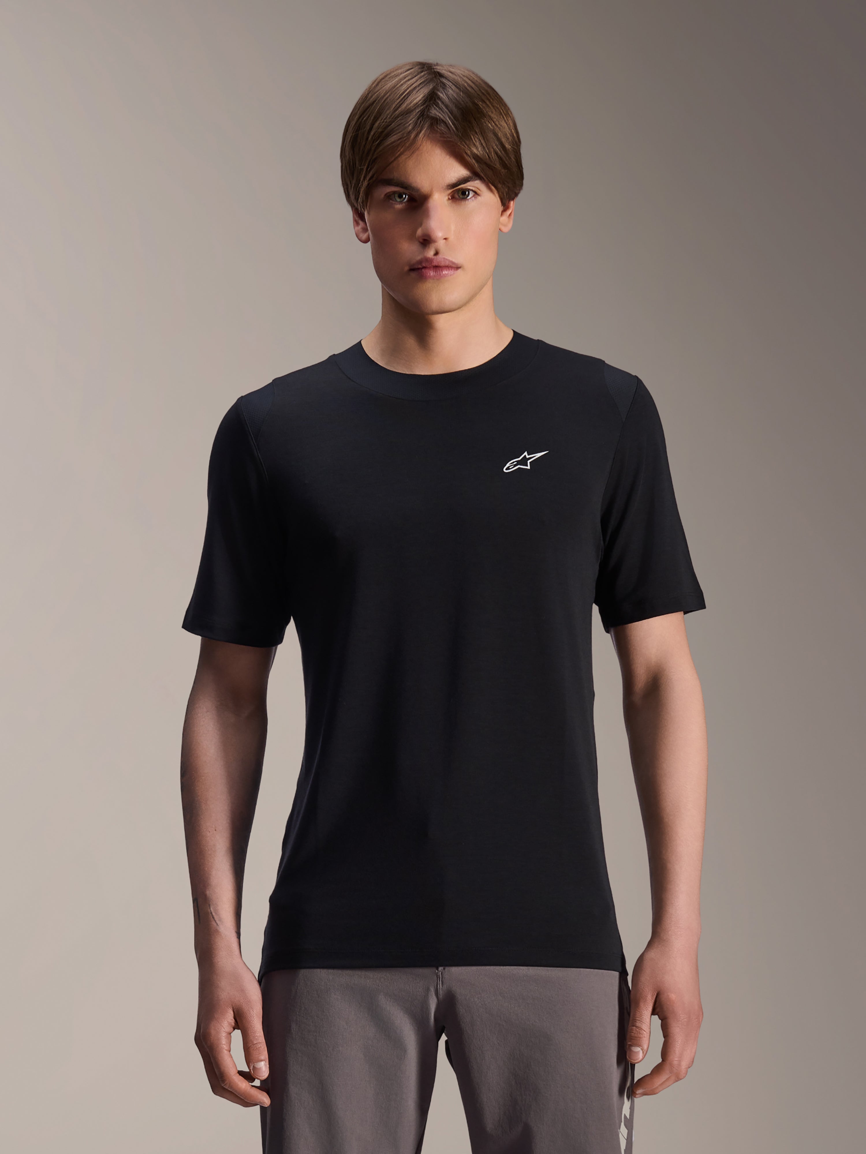 Alpinestars A-Dura Dri Wool Short Sleeve Jersey, Black, worn by male model, small white Alpinestars logo on chest, performance cycling apparel for MTB trail riding, moisture-wicking drirelease wool fabric