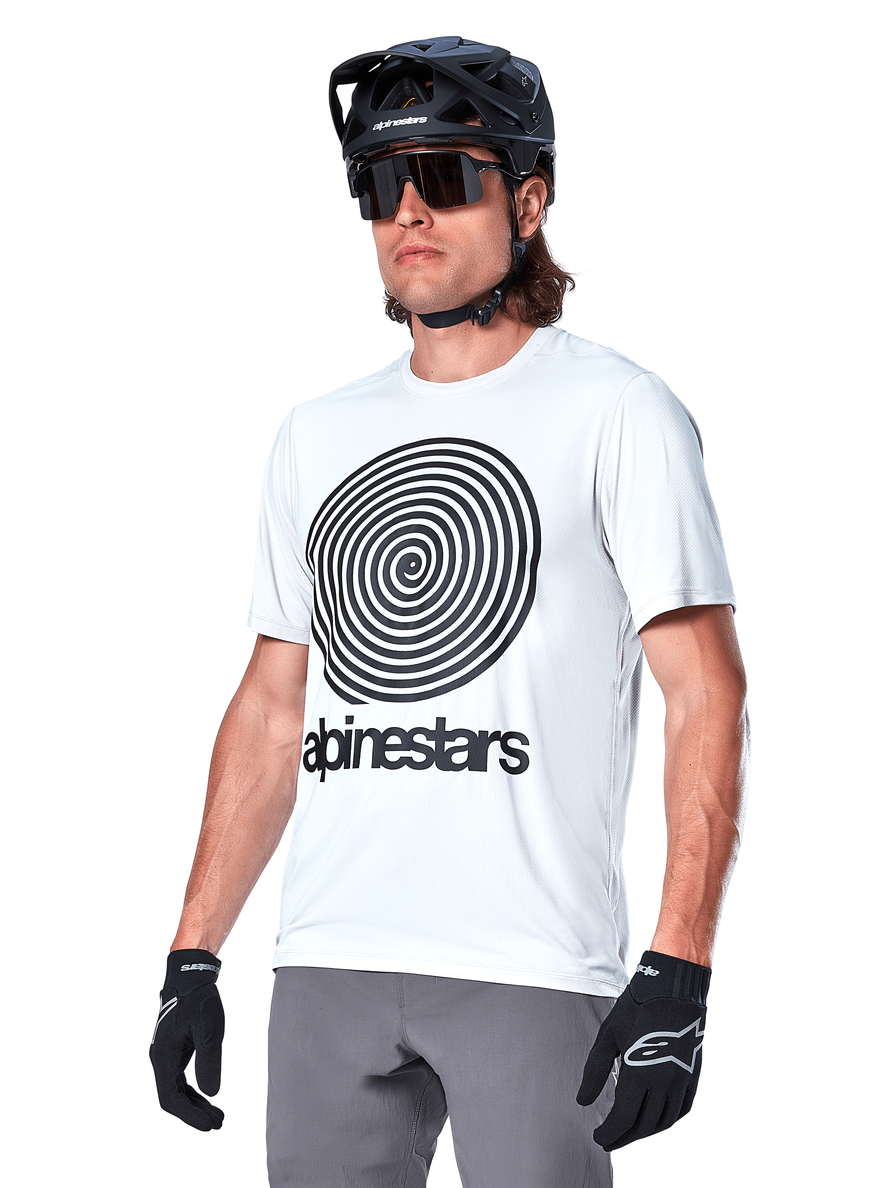 Alpinestars A-Dura Oscar Jersey - Short Sleeve, White Dove with black heritage spiral graphic and logo, worn with black MTB helmet and gloves, sporty performance mountain bike apparel