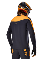 Alpinestars A-Supra Race Jersey - Long Sleeve, Black and Orange, back view of rider wearing matching helmet and mountain bike pants, performance fit with micro-perforated texture, professional MTB racing gear