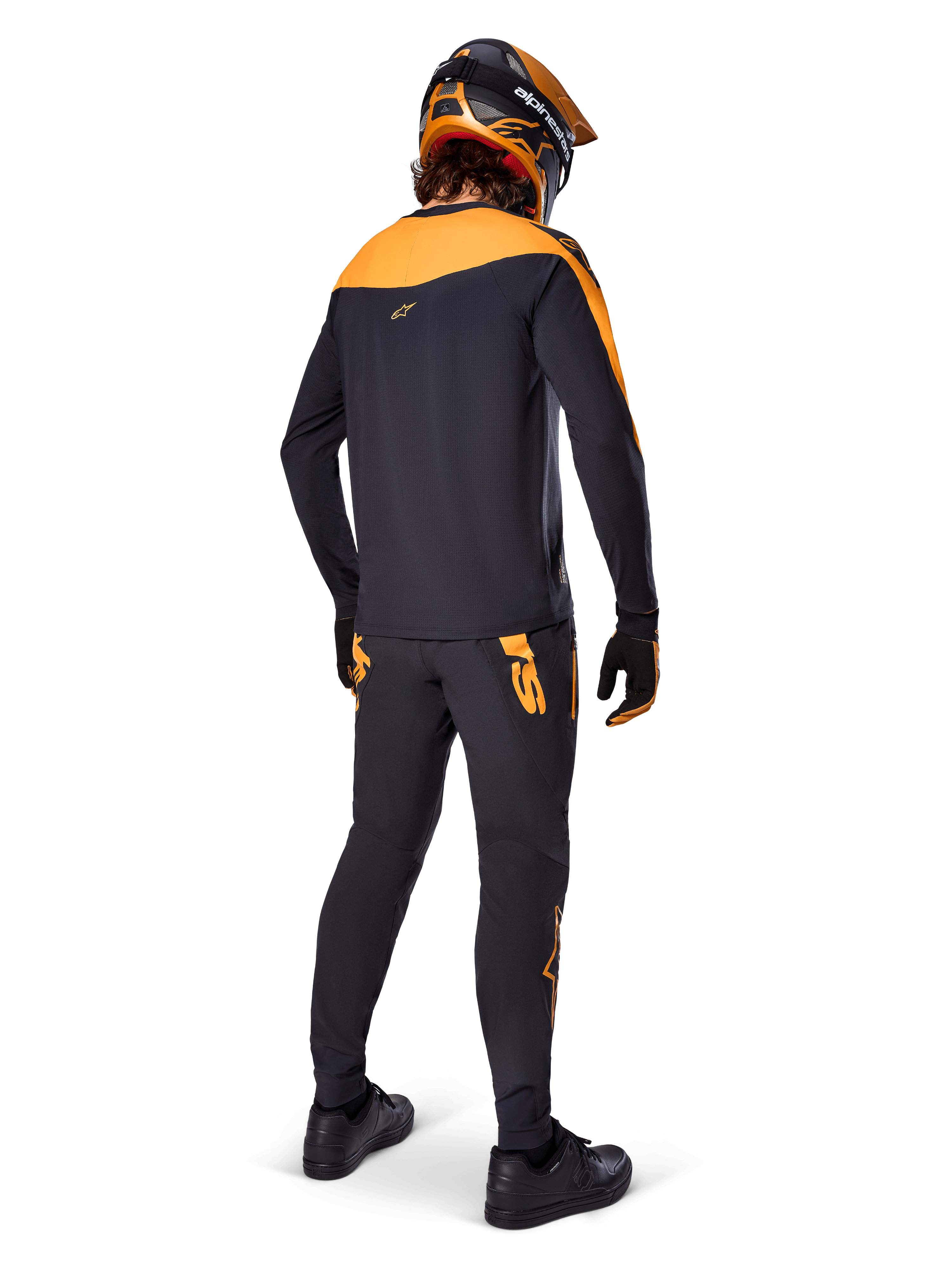 A-Supra Race Jersey - Long Sleeve, Black and Orange, rear view of a rider wearing matching MTB pants, orange and black helmet, and gloves, performance gear for mountain bike racing