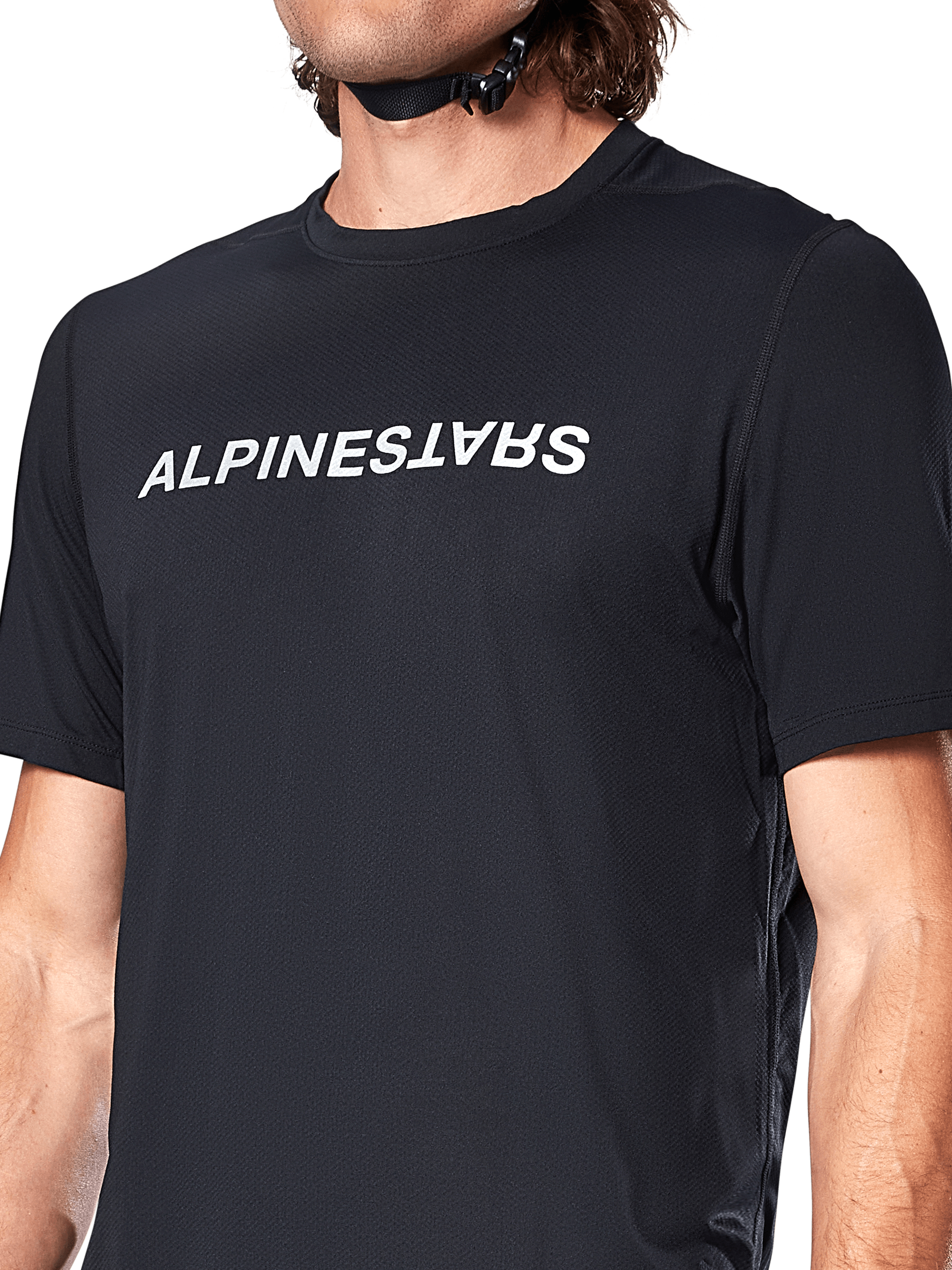 Maillot à manches courtes Alpinestars A-Dura Switch, noir, arborant un grand logo textuel blanc sérigraphié sur la poitrine, texture du tissu jacquard technique, vue de face en gros plan