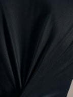 Détail du tissu jacquard noir du maillot Stella A-Dura Ride, texture respirante et extensible haute performance.