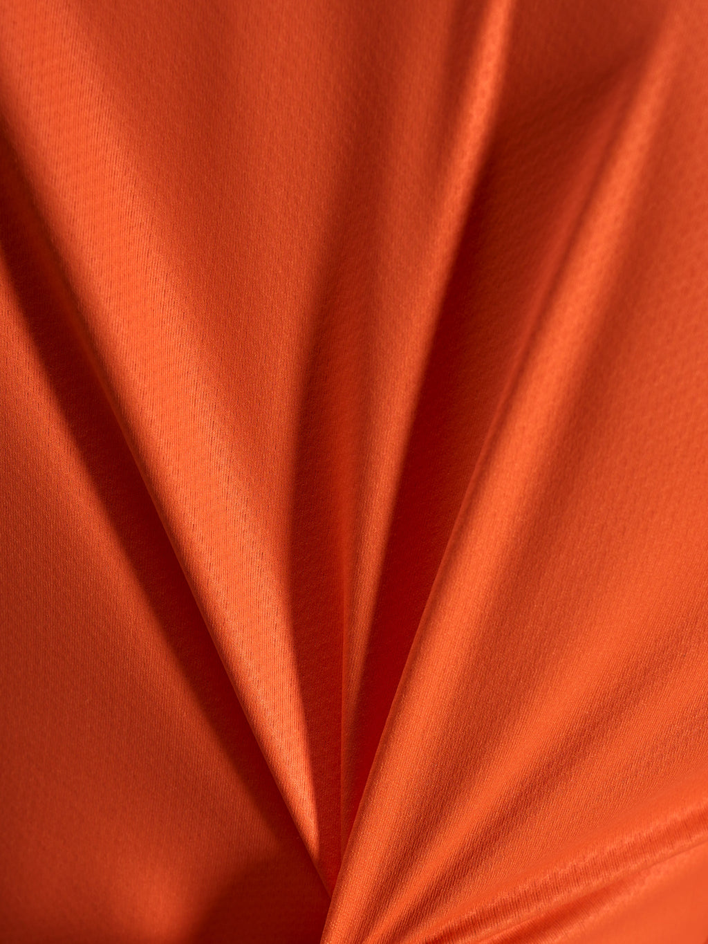 Détail du tissu jacquard orange du maillot Alpinestars Stella A-Dura Ride, texture légère et extensible.