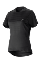 Alpinestars Women Stella Alps Constellation Jersey, Short Sleeve Mountain Bike Jersey, Black with subtle horizontal stripes on chest, small white logo, round neckline, extended tail for coverage, lightweight breathable fabric for MTB