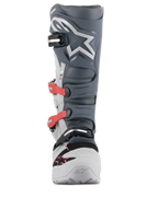 Bottes Alpinestars Tech 7 Enduro, bottes de motocross et d'enduro, gris clair, gris foncé et rouge vif, vue de face présentant un système de boucles avancé avec des sangles rouges, une plaque tibiale en TPU gris foncé avec logo étoile blanc et un châssis gris clair durable.