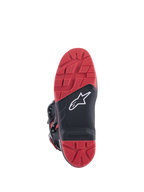 Bottes Honda Tech 7 Enduro Drystar®, noir et rouge vif, vue de la semelle montrant le motif de crampons à haute adhérence avec insert remplaçable, construction en caoutchouc à double densité et logo Alpinestars blanc sur panneau texturé noir.