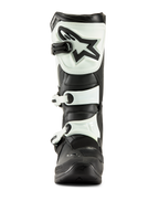 Bottes Alpinestars Tech 3, bottes de motocross, noir et blanc, vue de face montrant la plaque tibiale en TPU blanc avec logo étoile noir et sangles à boucles blanches, équipement tout-terrain durable