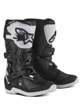 Alpinestars Youth Tech 3S Boots, Motocross Boots for young riders, Black and White, featuring three adjustable buckle straps, white TPU shin plate with Alpinestars logo, reinforced hard shell protection, and a sturdy white treaded sole, off-road racing design