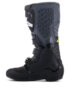 Bottes Alpinestars Tech 5, bottes de motocross, noir et gris froid avec accents jaune fluo, profil latéral montrant une construction haute multi-panneaux, système de fermeture à boucles et plaque de tibia texturée avec logo embossé, chaussures de course tout-terrain