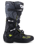 Bottes Alpinestars Tech 5, bottes de motocross tout-terrain, vue de profil, noir et gris froid avec accents jaune fluo, motif camouflage, boucles réglables et semelle de protection robuste.