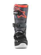 Alpinestars Youth Tech 7S Boots, Motocross Boots, Black and Dark Gray with Fluorescent Red accents, front view, featuring TPU shin plate with red star logo, three buckle closure system, and white integrated sole, durable off-road protective gear