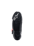 Bottes Alpinestars Supertech R, vue de la semelle, composé de caoutchouc léger noir avec motif d'adhérence texturé, logo étoile Alpinestars blanc, chaussures de course moto haute performance